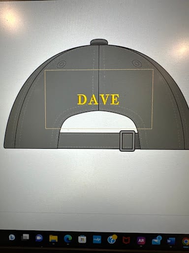 Back view of grey cap with yellow embroidered name DAVE