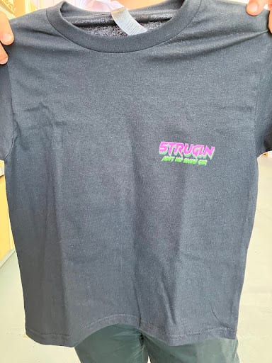 Dark navy kids t-shirt with embroidered green and pink logo on chest