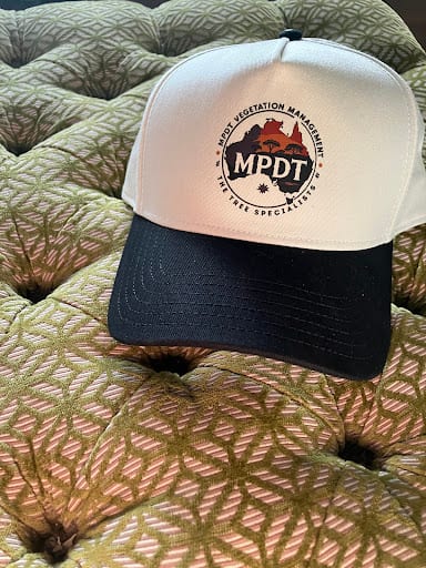 White and navy trucker cap with MPDT Vegetation Management embroidered logo